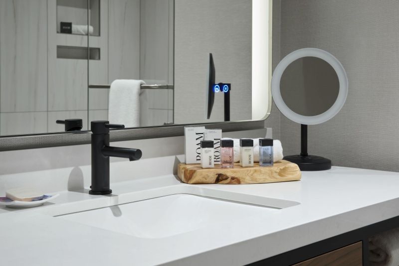 Bathroom sink with sink, amenity products, and mirror