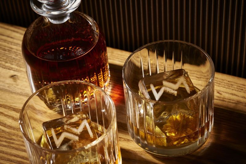 Two glasses of scotch with engraved ice cubes