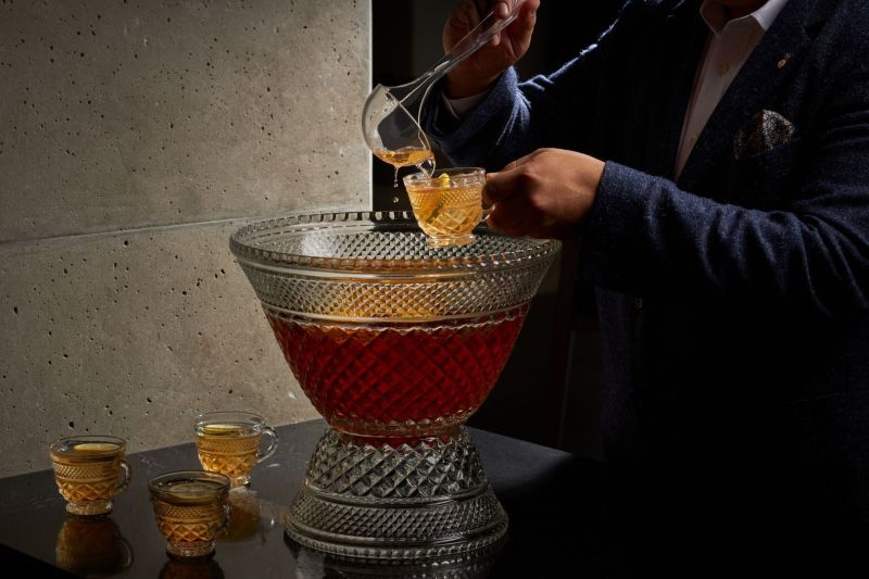 Large crystal punch bowl wither person serving them self a glass