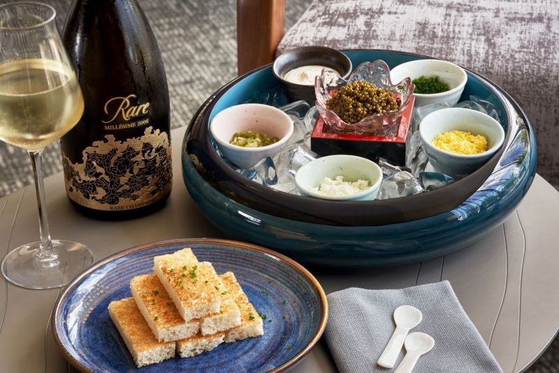 Food spread setup with a glass of wine