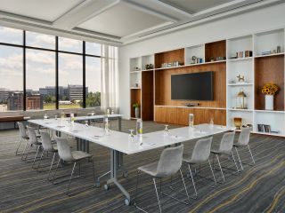 A Meeting Room Set Up With A U-Shaped Table With A Large Window