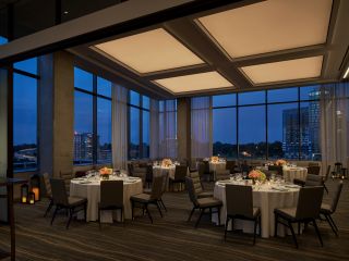 A Meeting Room Set Up During the Evening For a Reception-Style Event