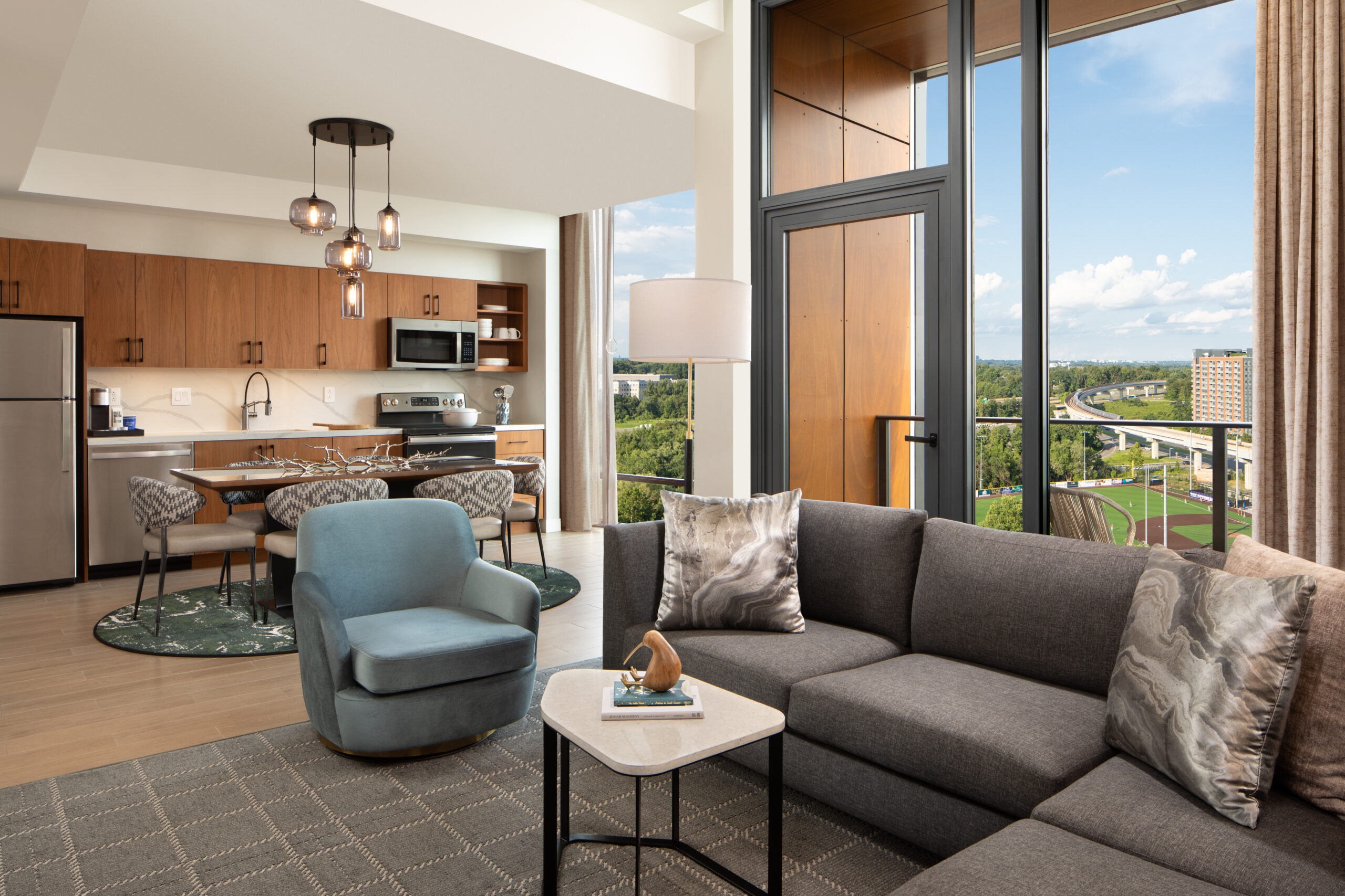 Sofa and table with kitchen and windows in background.