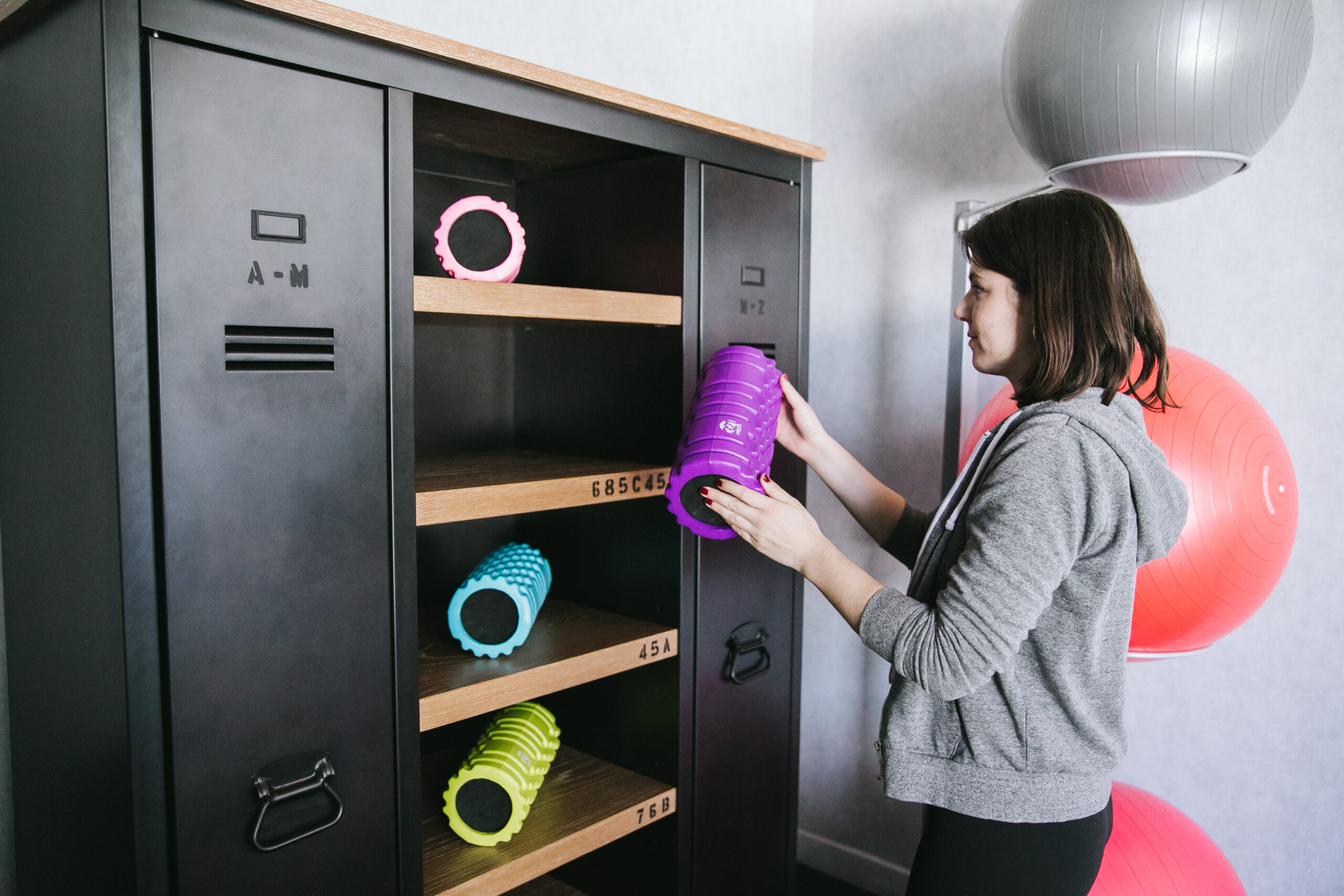 Wman placing a mat on a shelf.